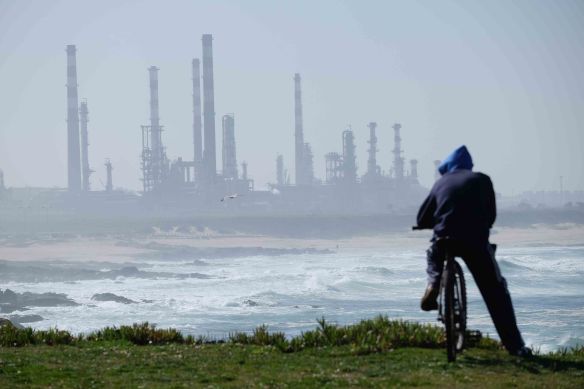 Cyclist looking at factories