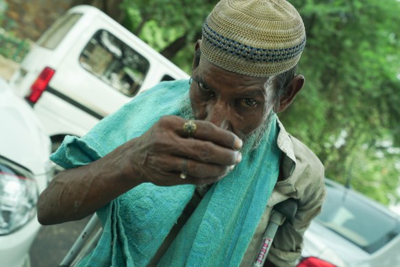 man with hand over mouth